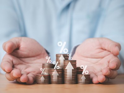 Two hand giving heap of coins money with up arrow and percentage symbol for financial banking increase interest rate