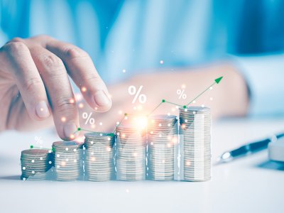 Two hand giving heap of coins money a sparkle with an arrow up